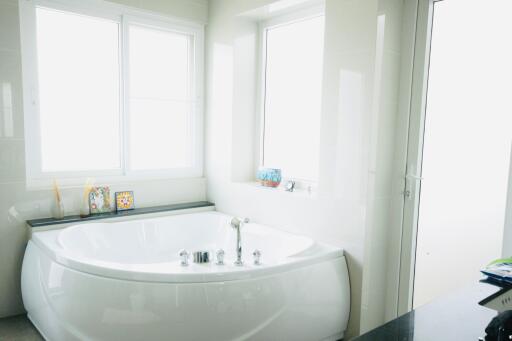 Bathroom with a bathtub and bright lighting