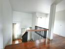 Modern staircase with wooden steps and black railings in a bright home