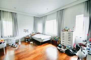 Spacious and bright bedroom with wooden floors