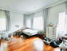 Spacious and bright bedroom with wooden floors