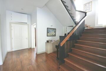 Spacious modern hallway with wooden stairs