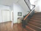 Spacious modern hallway with wooden stairs