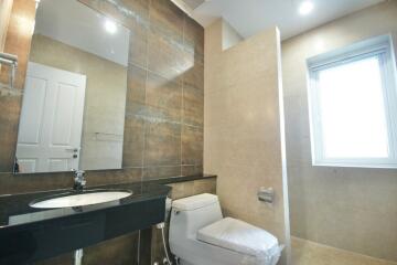 Modern bathroom with large mirror and window