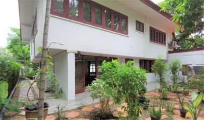 Two-story house exterior with garden