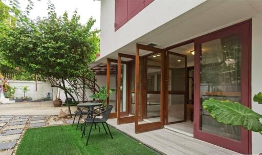 Outdoor seating area with lush greenery