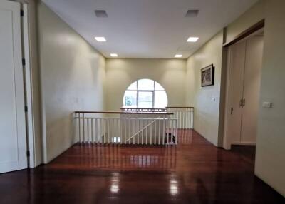 Second floor open area with railing and circular window