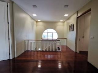 Second floor open area with railing and circular window