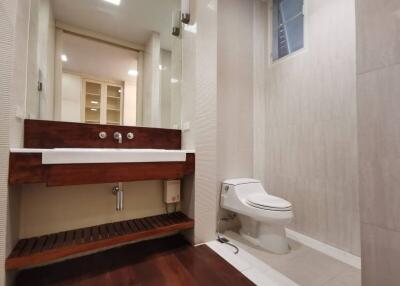 Well-lit modern bathroom with toilet and sink