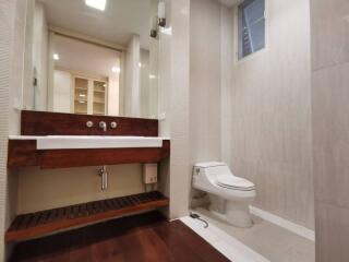 Well-lit modern bathroom with toilet and sink