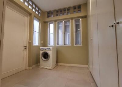 Laundry room with washing machine and ample storage space