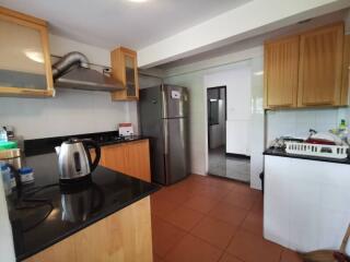 Modern kitchen with wooden cabinetry and stainless steel appliances