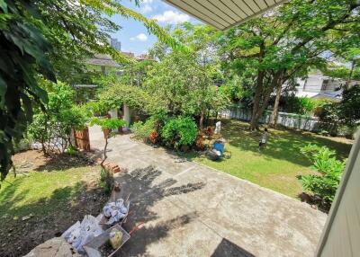 Spacious backyard with greenery and paved area