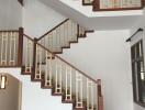 Modern indoor staircase with wooden railings