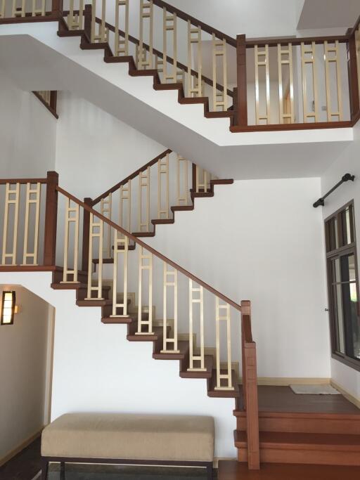 Modern indoor staircase with wooden railings