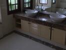 Bathroom with double vanity sinks and marble countertop