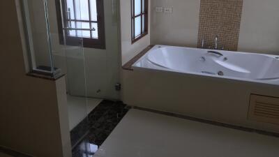 Bathroom with bathtub and glass shower