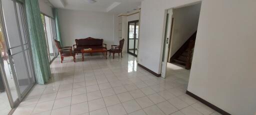 Spacious living room with large windows and traditional furniture