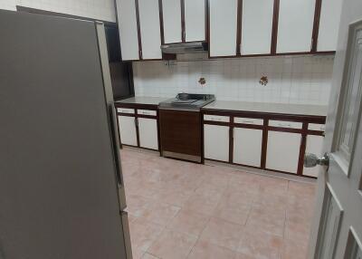 A view of a kitchen with cabinets and appliances