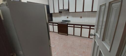 A view of a kitchen with cabinets and appliances