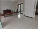 Spacious living room with tile flooring and wooden furniture