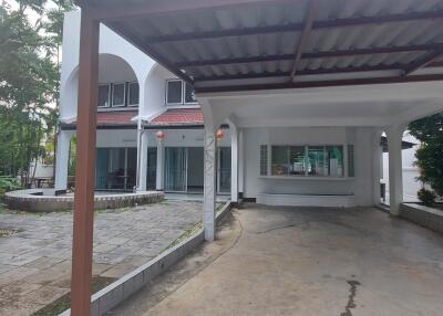 Front view of the house with garage and garden area