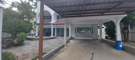 Front view of the house with garage and garden area