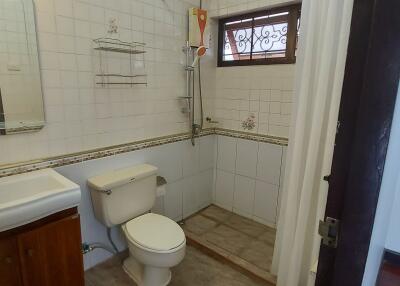 Modern bathroom with a walk-in shower, toilet, and sink