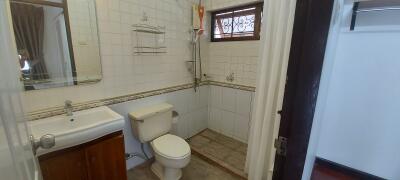 Modern bathroom with a walk-in shower, toilet, and sink