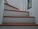 Interior staircase with wooden steps and railing