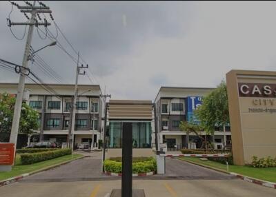 Gated townhouse community entrance with visible townhouses