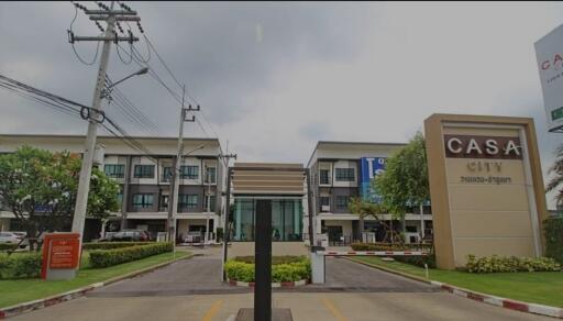 Gated townhouse community entrance with visible townhouses