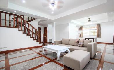 Spacious living room with staircase and modern furniture