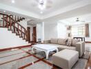 Spacious living room with staircase and modern furniture