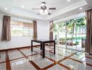 Spacious living room with floor-to-ceiling windows and modern ceiling fan