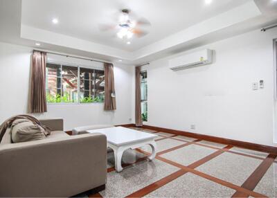 Modern living room with sofa, coffee table, air conditioner, and large window