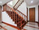 Wooden staircase with polished railing in a bright indoor area