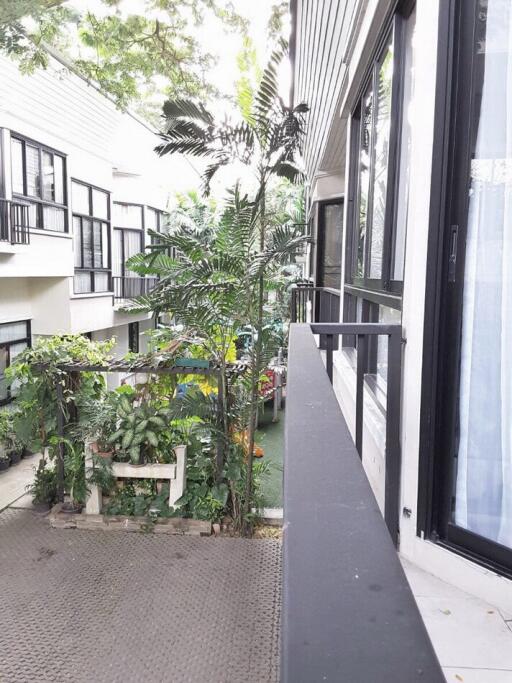 Exterior view of building with balcony and greenery