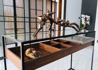 Decorative table with modern sculpture and drawer