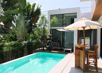 Modern house with swimming pool and outdoor seating area