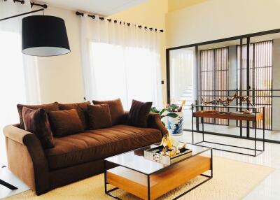 Modern living room with brown sofa and glass coffee table