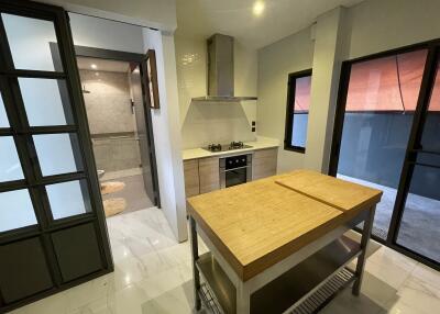 Modern kitchen with island and adjacent bathroom