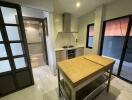 Modern kitchen with island and adjacent bathroom