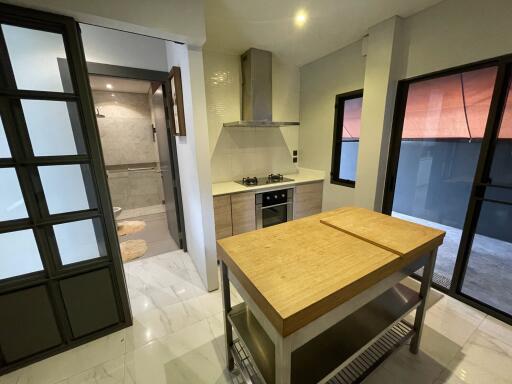 Modern kitchen with island and adjacent bathroom