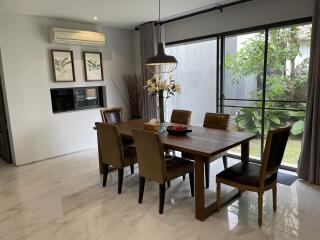 Modern dining room with wooden table and leather chairs