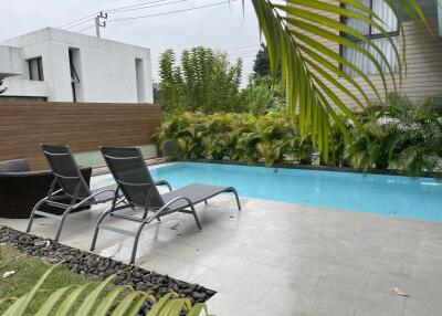 Outdoor pool area with lounge chairs