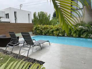 Outdoor pool area with lounge chairs