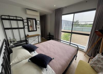 Modern bedroom with large window and stylish decor