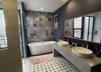 Modern bathroom with freestanding bathtub and double sink vanity