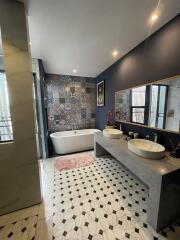 Modern bathroom with freestanding bathtub and double sink vanity