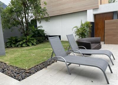 Patio with lounge chairs and greenery